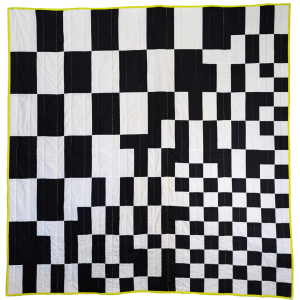 black and white checkerboard quilt with yellow border